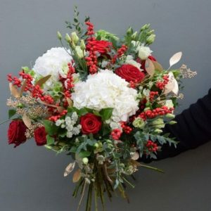 Luxury Christmas bouquet of seasonal reds, greens and whites available from Kensington Flowers London