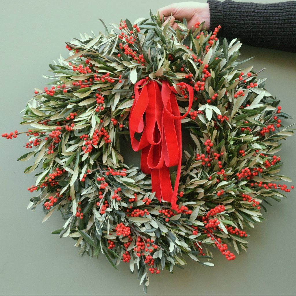 Sample of The Luxury George Christmas wreath simply olive foliage with fresh red ilex berries available to order from Kensington Flowers London