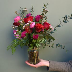 Photo showing a sample image of a Valentine Jar of seasonal flowers, in red and pink colours available to order from Kensington Flowers, London