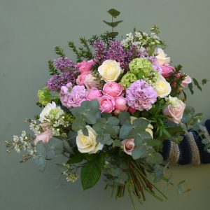 Photo showing a sample of a Mother's Day bouquet in pink and lilac colours, including roses and scented stocks. Available to order from Kensington Flowers London